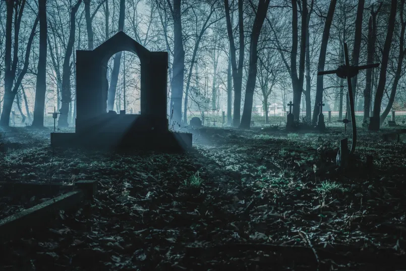 Bachelors Grove Cemetery abandoned tombstones Overgrown cemetery with tilted and broken gravestones in a wooded area