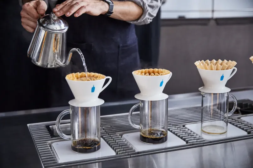 Barista performing a precise pour-over coffee preparation at a minimalist San Francisco café