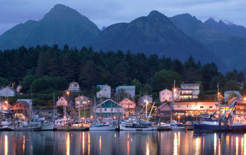 Boats in Sitka harbor with snow-capped mountains of Baranof Island in background