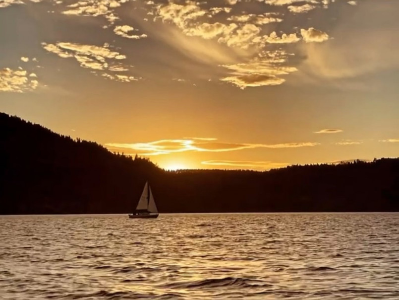 Flathead Lake Montana sunset boats Boats moored on Flathead Lake at sunset with Mission Mountains in background