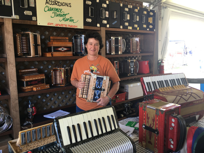 Elderly Cajun musician playing traditional button accordion