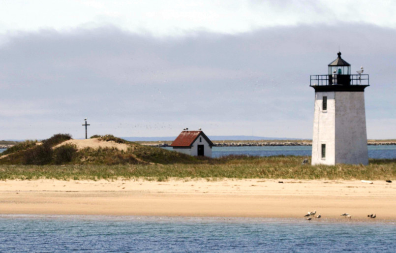 Cape Cod Massachusetts beach dunes lighthouse Cape Cod beach with sand dunes and historic lighthouse in the background