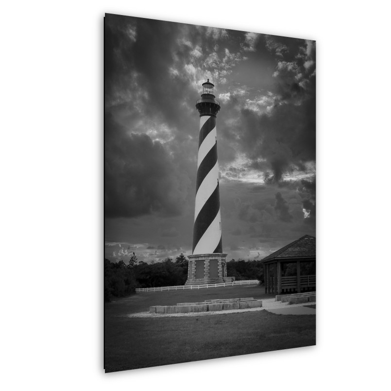 Cape Hatteras Lighthouse black white spiral stripes Tall lighthouse with distinctive black and white spiral pattern against blue sky