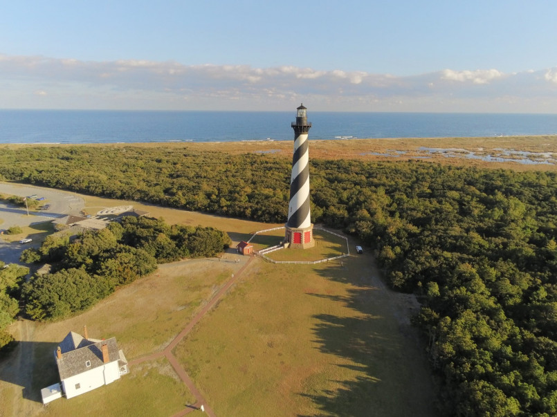 Cape Hatteras lighthouse with pristine beach stretching into the distance