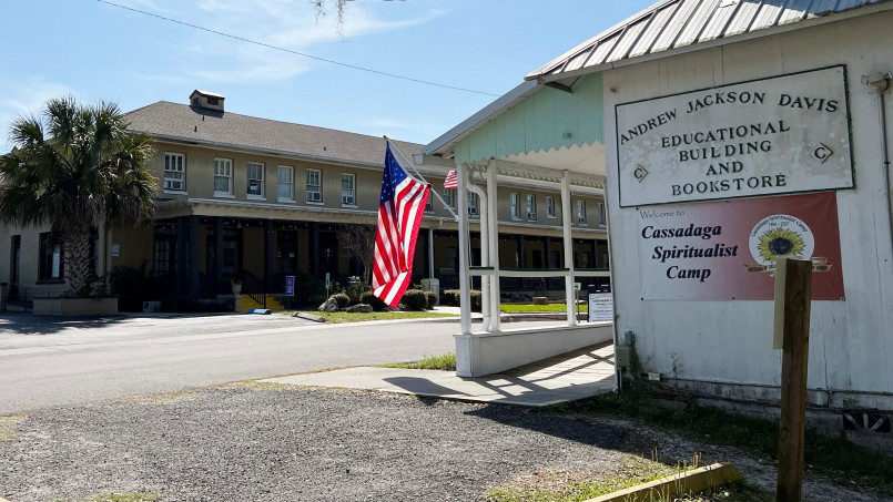 Welcome sign to the Cassadaga Spiritualist Camp in Florida with psychic services advertised