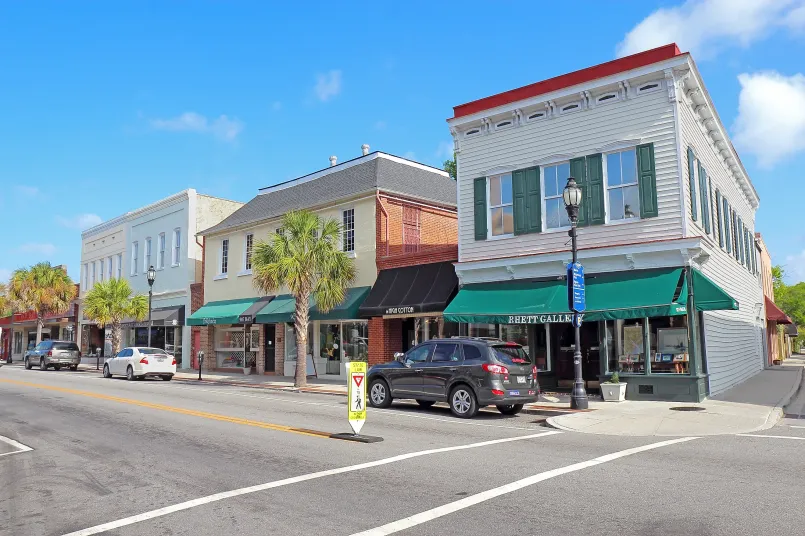 College town street with shops and students Typical college town main street with local shops, cafes and students walking