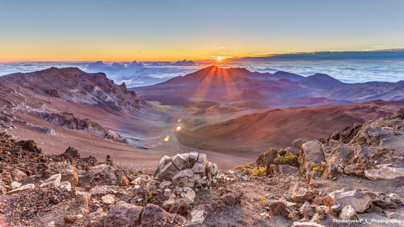 Colorful sunrise over the vast crater of Haleakala volcano on Maui