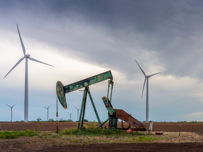 Contrasting energy landscape showing both renewable and fossil fuel infrastructure in a rural state