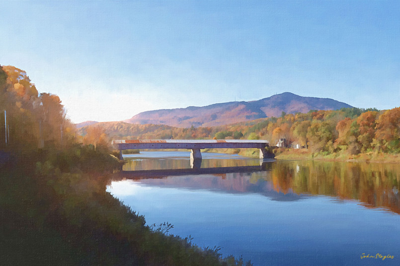 Long red covered bridge spanning the Connecticut River between two states