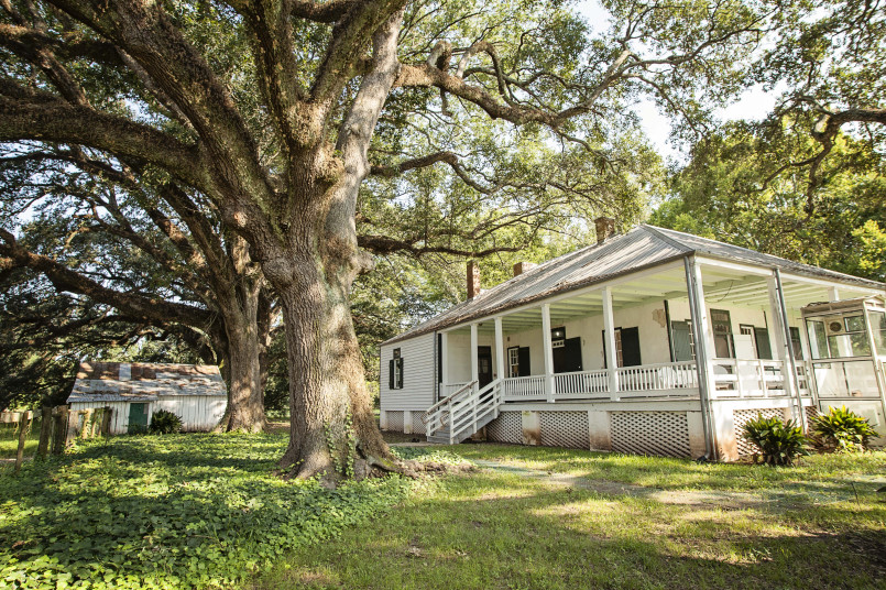 Historic Creole plantation house with wide front gallery and brick columns