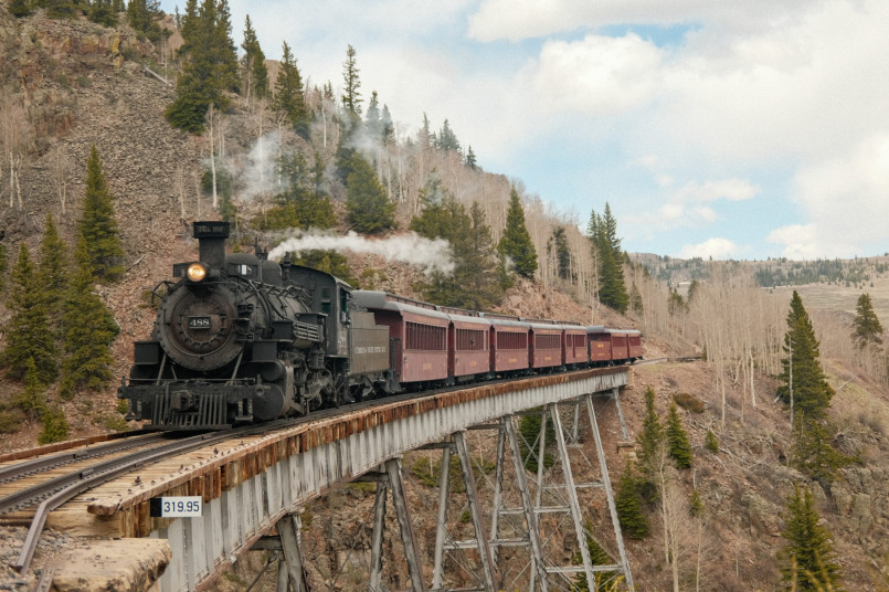 Cumbres toltec railroad mountain pass Steam train crossing high mountain trestle in Colorado