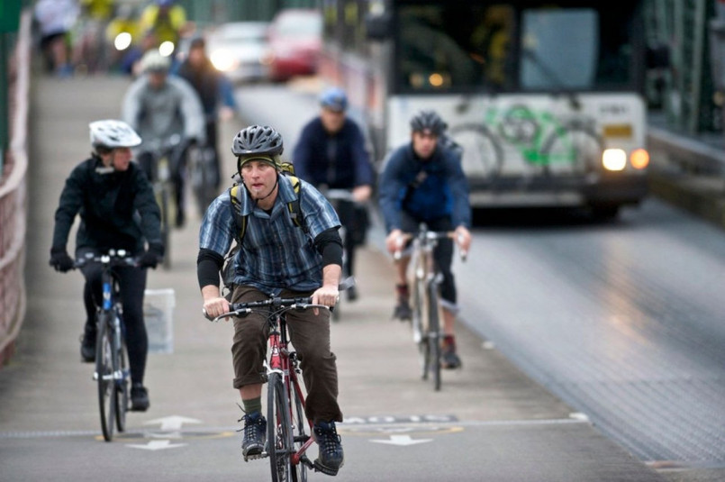 Cyclists commuting on a busy Portland bike boulevard during rush hour