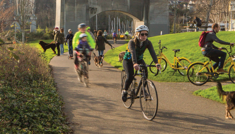Cyclists on the Burke-Gilman Trail in Seattle with water views