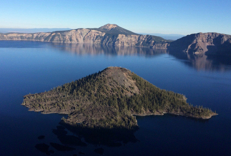 Deep blue waters of Crater Lake with Wizard Island and snow-dusted caldera rim