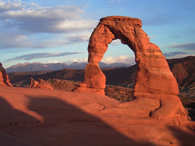 Delicate Arch glowing orange-red at sunset in Arches National Park