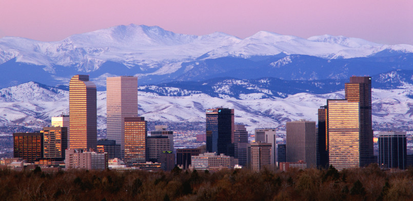 Denver's modern skyline with Rocky Mountains visible in the background