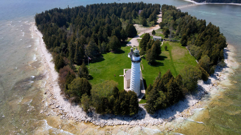 Door county wisconsin lighthouse harbor Historic lighthouse overlooking Lake Michigan harbor with boats