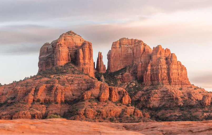Dramatic red rock formations with Cathedral Rock in Sedona against blue sky