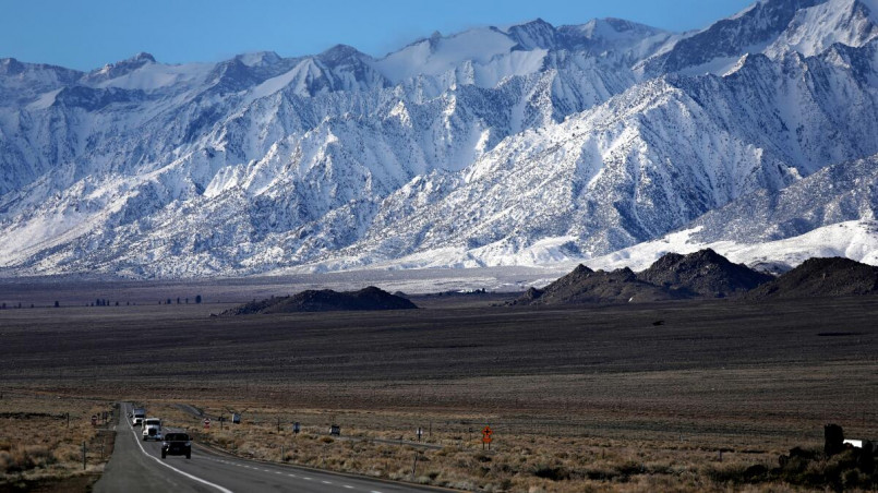 Dry, barren Owens Valley landscape with Sierra Nevada mountains rising dramatically in the background
