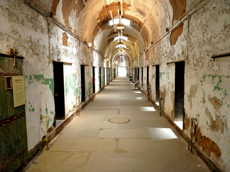 Eastern State Penitentiary cell block Abandoned cell at Eastern State Penitentiary with crumbling walls and rusted bed frame