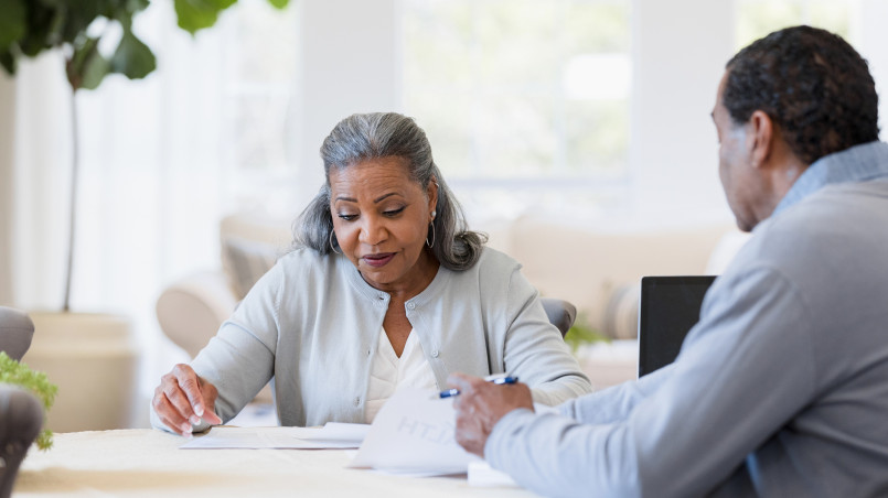 Senior woman examining survivor benefit paperwork