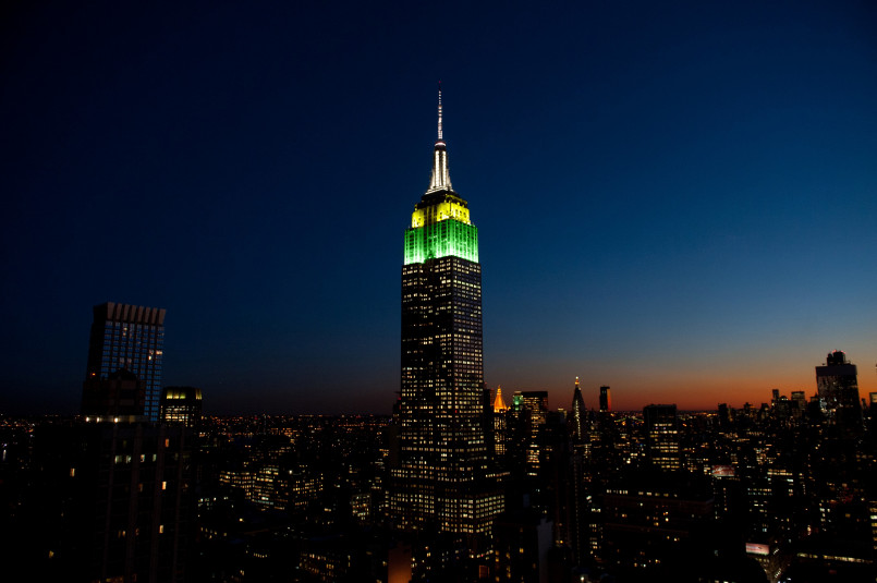 Empire State Building illuminated at night against the Manhattan skyline