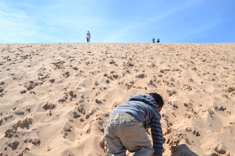 Family climbing sleeping bear dunes michigan Family climbing the giant sand dunes at Sleeping Bear Dunes National Lakeshore