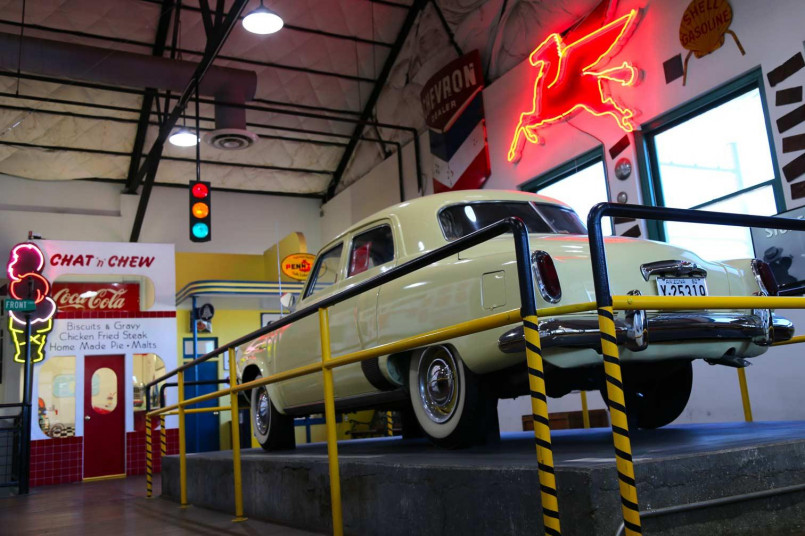 Family route 66 classic car museum Family exploring vintage cars at Route 66 museum