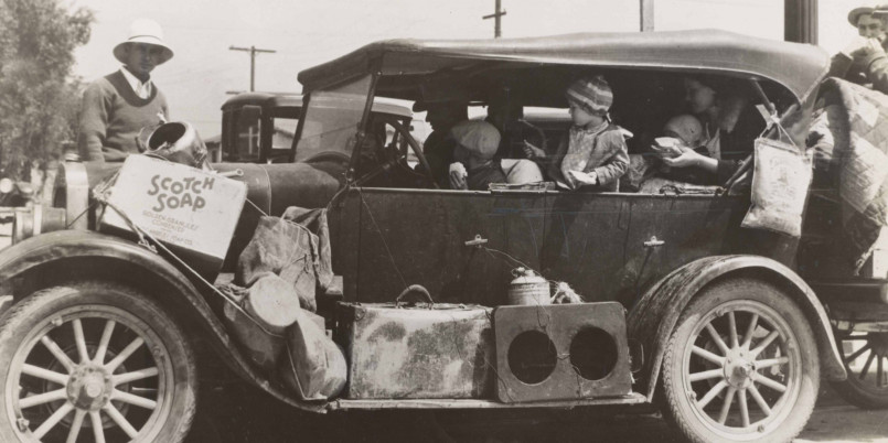 Family with all their belongings packed on their car, migrating west during the Dust Bowl