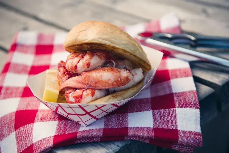 Fresh Maine lobster roll being served at a waterfront restaurant in Kennebunkport