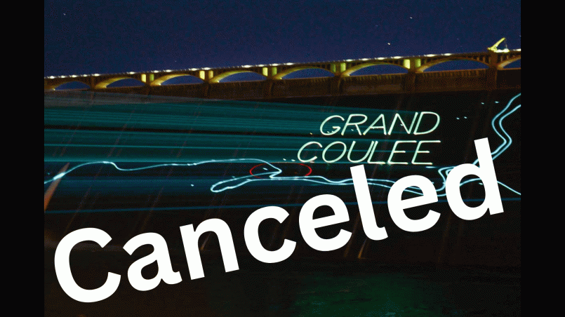Grand Coulee Dam illuminated with colorful laser light show at night
