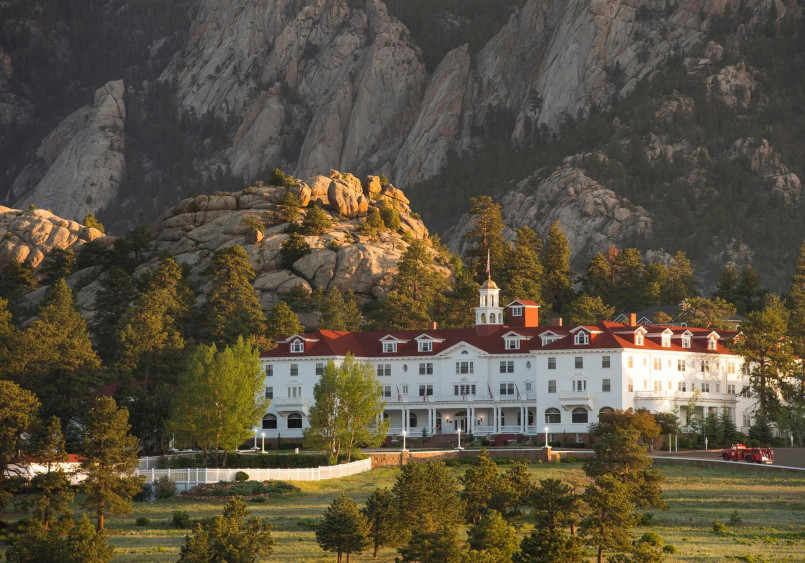 Stanley Hotel Colorado exterior Grand white exterior of the Stanley Hotel with mountains in the background