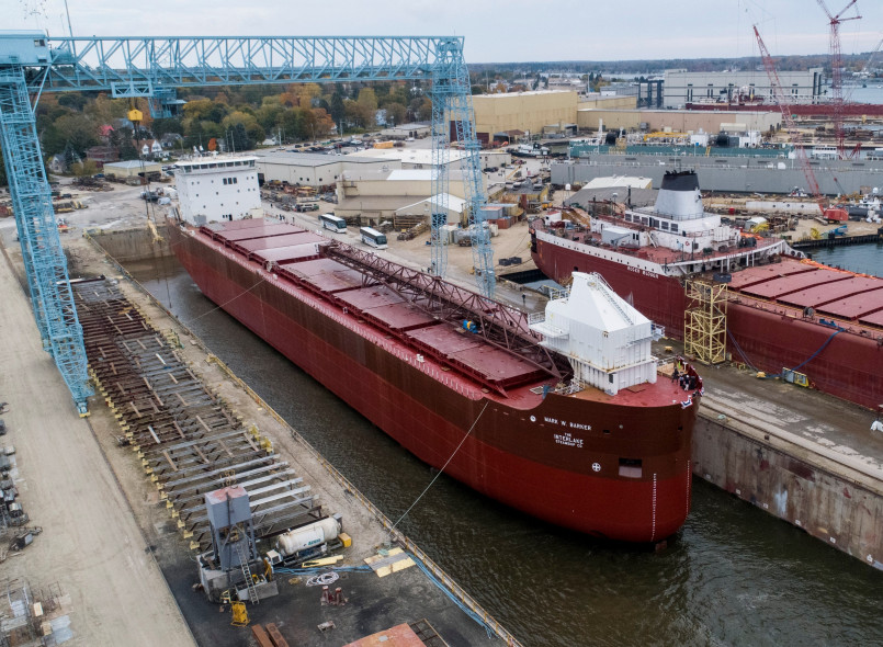Great lakes freighter ship ore carrier A massive lake freighter carrying iron ore traversing the Great Lakes waterway system