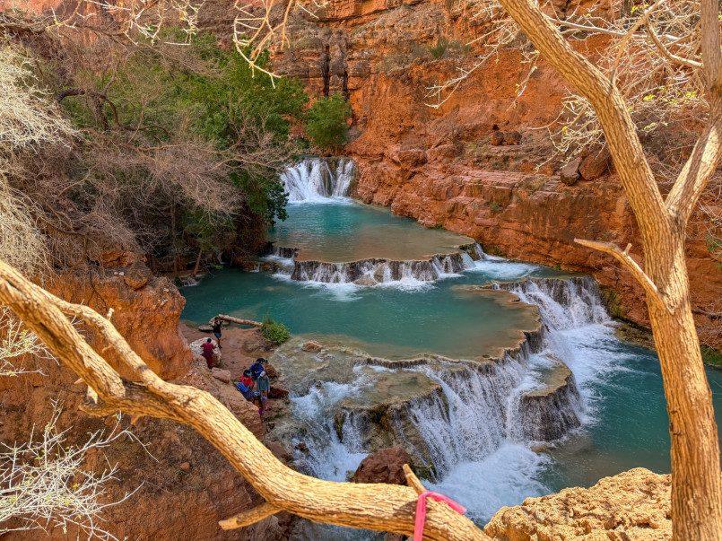 Havasu Falls turquoise water Supai Village Brilliant turquoise waterfall cascading into pools surrounded by red canyon walls near Supai Village