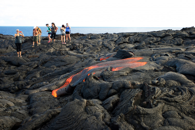 Red hot lava flowing into the ocean at Hawaii Volcanoes National Park on Big Island