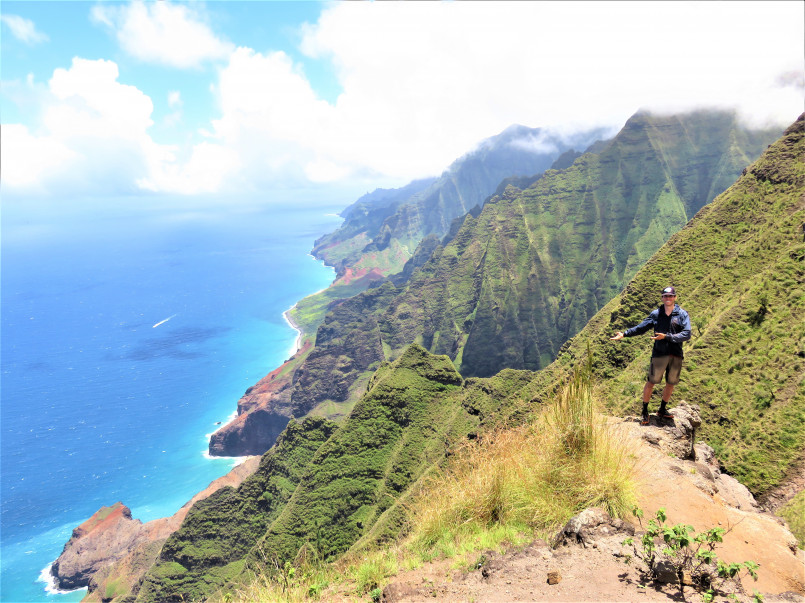 Hiker on the Kalalau Trail along Kauai's stunning Napali Coast