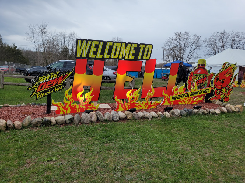 Hell Michigan welcome sign Welcome to Hell, Michigan sign with tourists taking photos