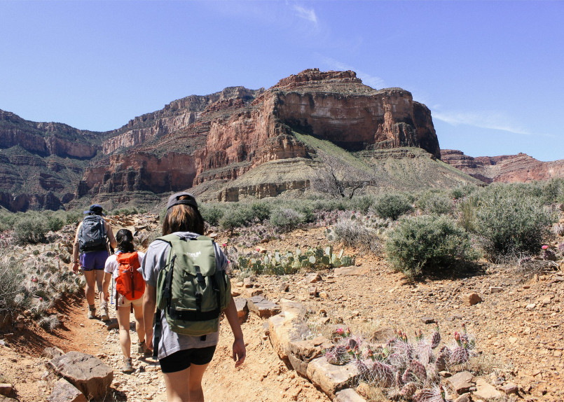 Hikers on switchbacks of the Bright Angel Trail with vast Grand Canyon views