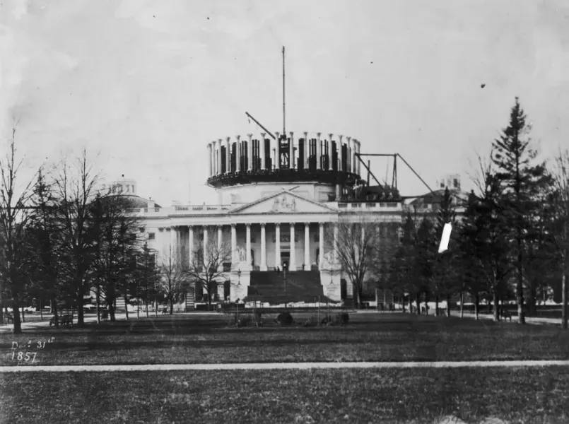 Historical illustration of the partially constructed US Capitol building in early Washington D.C.