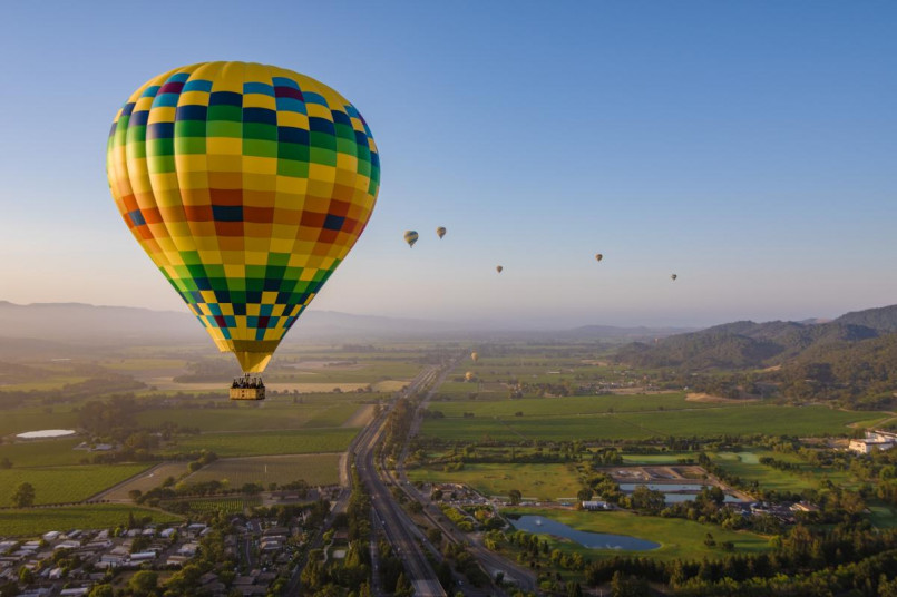 California wine country hot air balloon napa valley Hot air balloons floating over vineyards in Napa Valley at sunrise