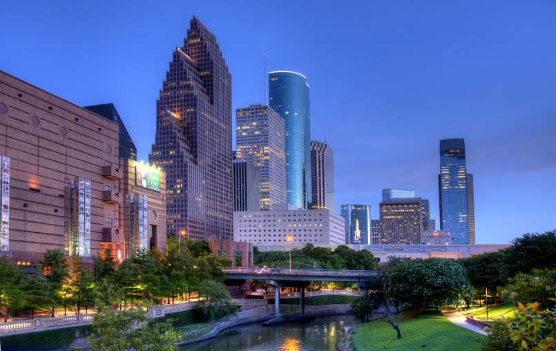 Houston skyline through a haze of summer humidity with people seeking shade