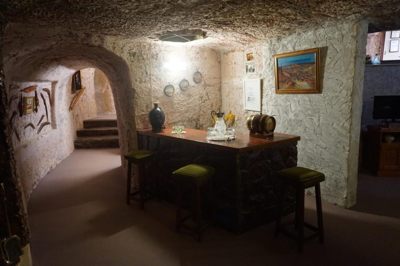 Interior of an underground home in Coober Pedy showing carved rock walls and modern furnishings