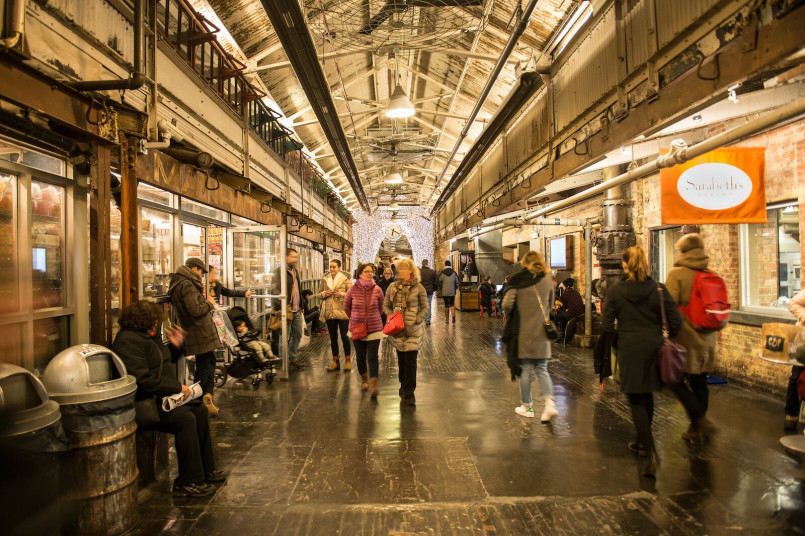 Interior view of Chelsea Market showing food vendors and historic industrial architecture