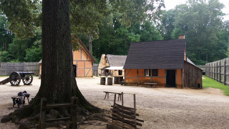 Jamestown Virginia historical settlement reconstruction Reconstructed colonial settlement at Jamestown with period buildings and costumed interpreters demonstrating 17th century life
