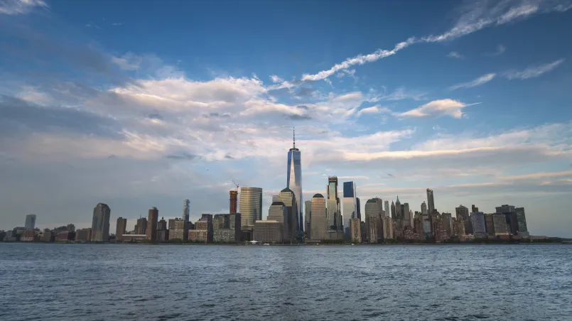 Jersey City waterfront showing modern high-rises with Manhattan skyline across the river