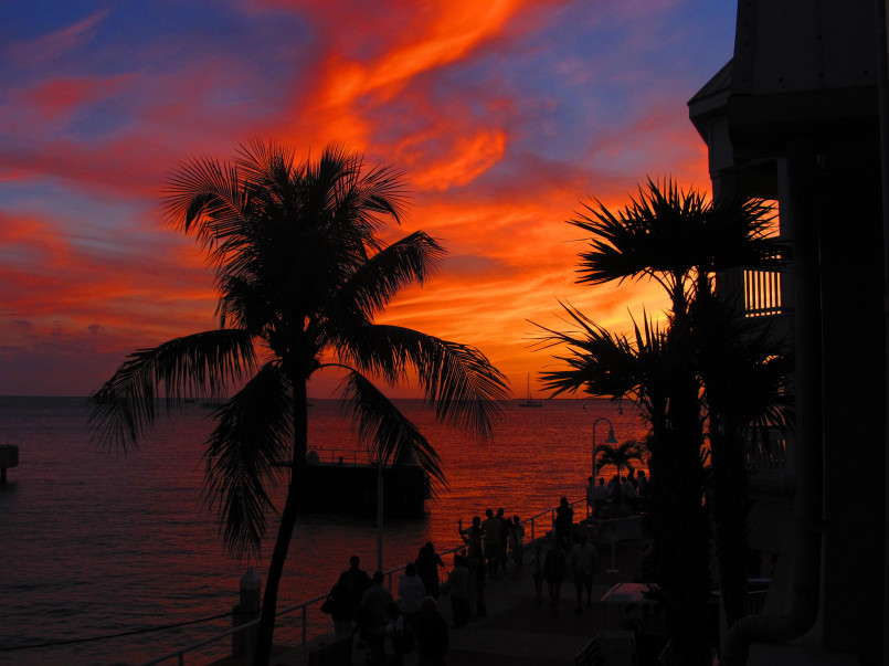 Colorful sunset at Mallory Square in Key West with street performers and gathered crowds