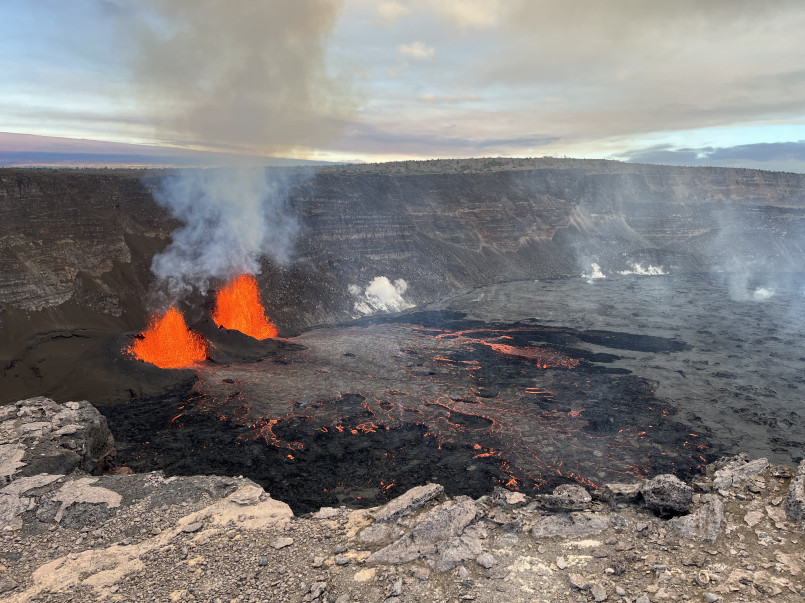 Kilauea volcano eruption hawaii earthquakes Glowing lava flow from Kilauea volcano on Hawaii's Big Island with seismic monitoring equipment in foreground