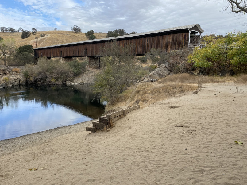 Long covered bridge over a river in California gold rush country