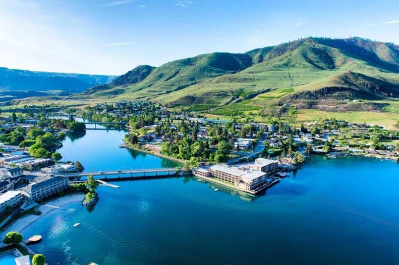 Lake Chelan Washington waterfront Lake Chelan waterfront with mountains in background and clear blue water