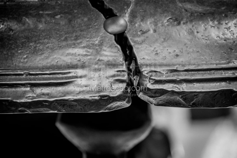 Detailed historical photograph showing the Liberty Bell's crack pattern and repair attempts